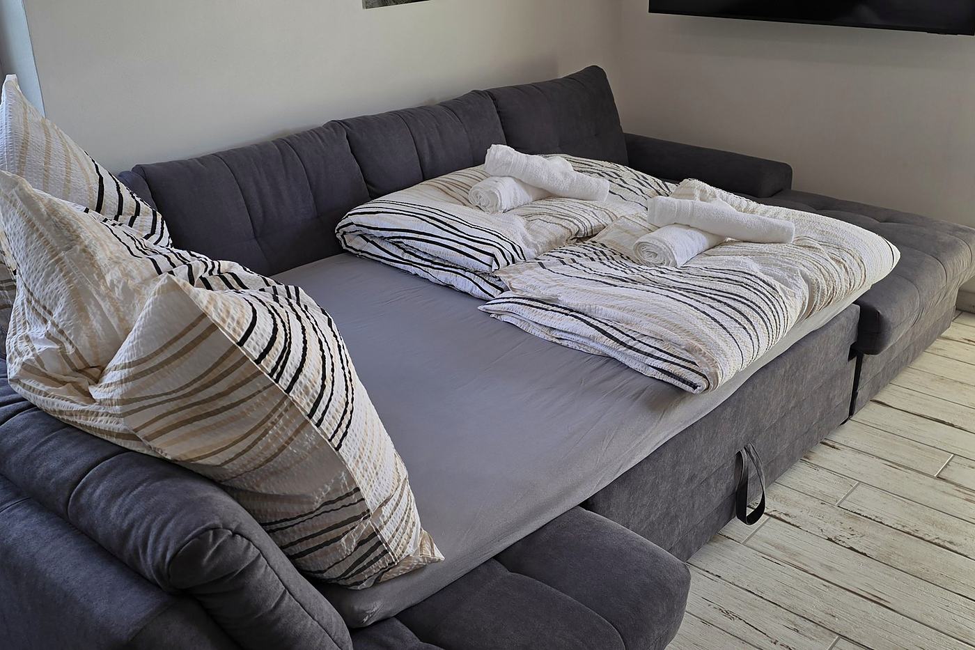 The sofa bed in the living room, made up