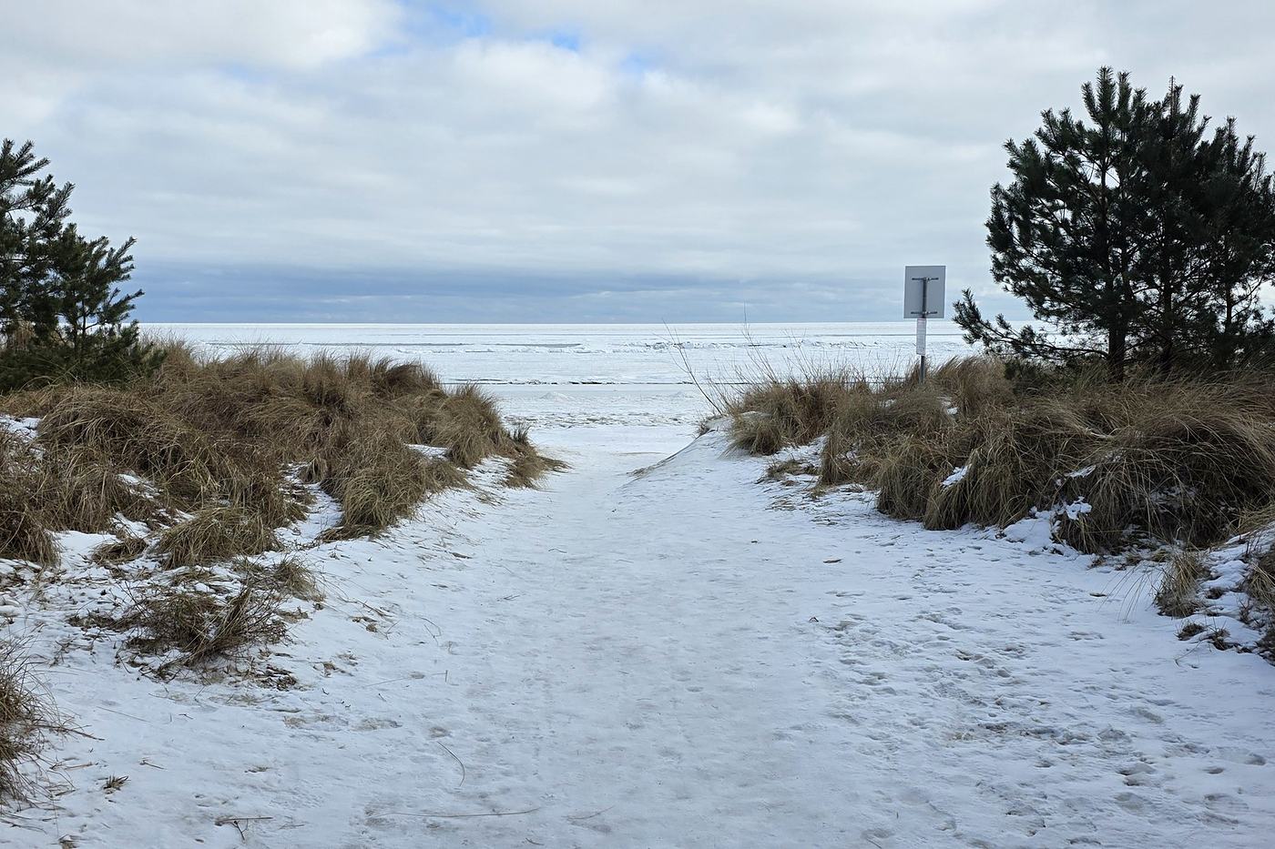 Snowy path through the dunes to the beach